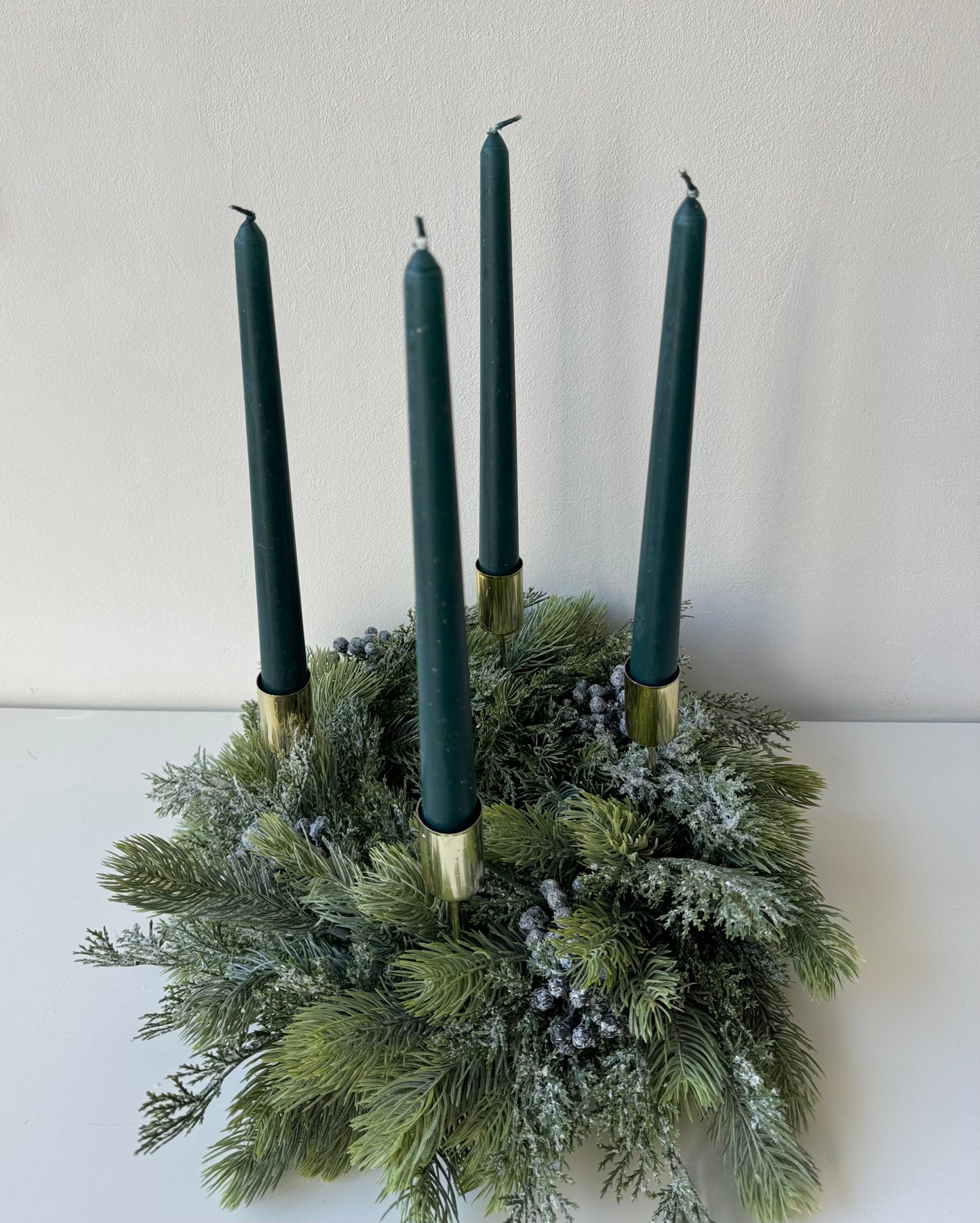 Advent wreath with snowy blue berries