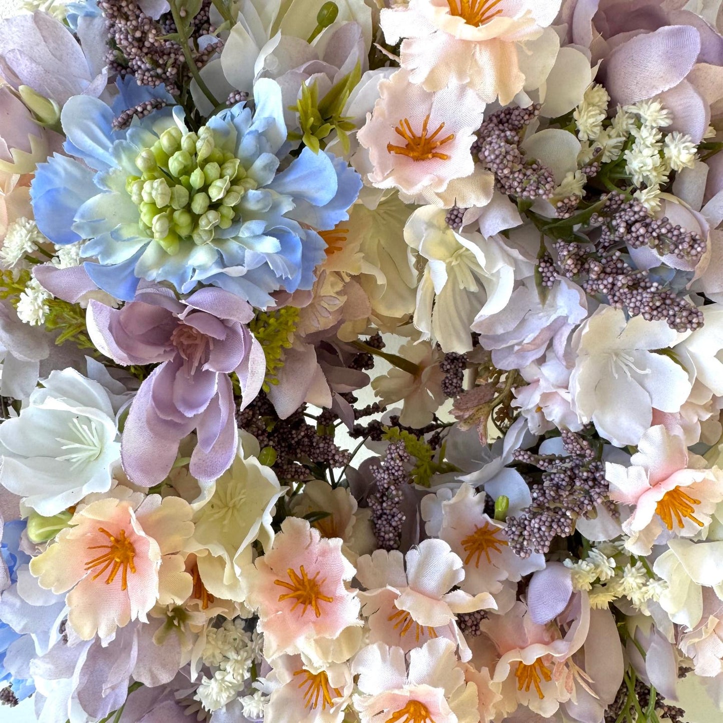 Spring door decoration with pastel flowers