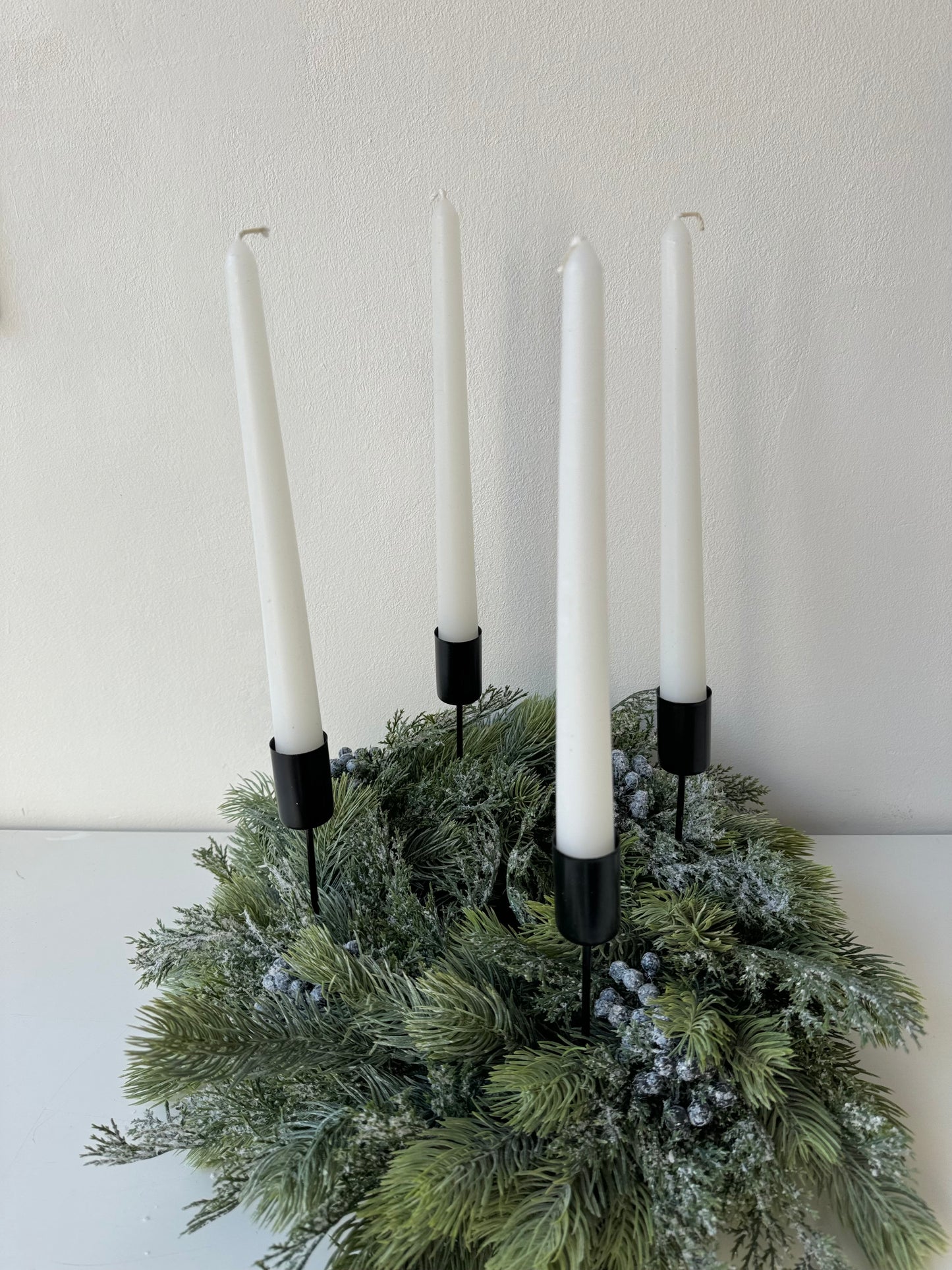 Advent wreath with snowy blue berries